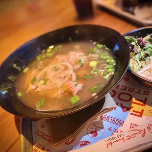a bowl of soup and a plate of salad
