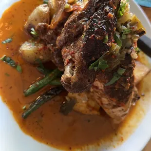 giannone moroccan chicken with roasted fingerling potatoes, sautéed green beans, harissa, scallions, au jus