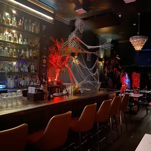 a bar with a skeleton on the wall