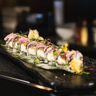 a sushi roll on a black plate