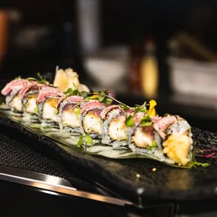 a sushi roll on a black plate