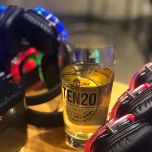 a glass of beer and a pair of luggage