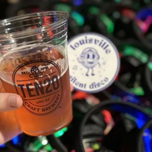 a person holding a glass of beer