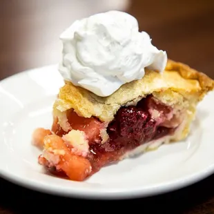 a piece of pie with whipped cream on top