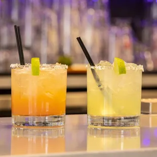 two cocktails on a bar