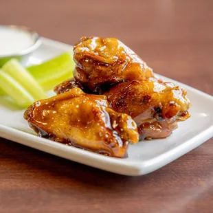 a plate of chicken wings and celery