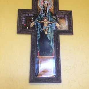 a cross with a picture of the virgin and child on it