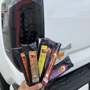 a person holding a bunch of meats