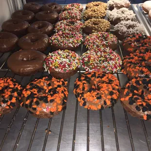 a variety of doughnuts on a cooling rack
