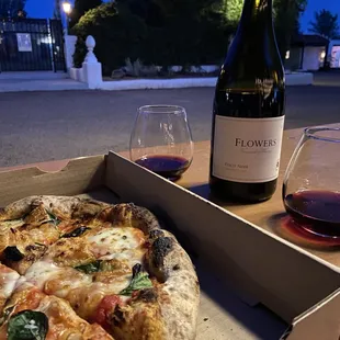 a pizza and a glass of wine
