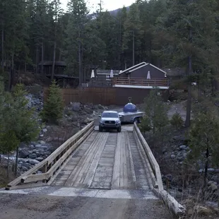 a car crossing a wooden bridge