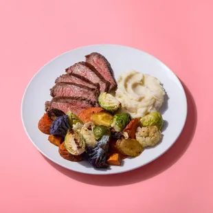 a plate of meat, vegetables, and mashed potatoes