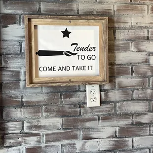 a sign on a brick wall