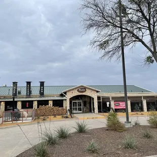 Exterior.  Building is set back from the road, behind a Hooters.