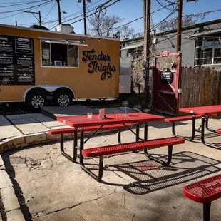 Plenty of tables , some under a tent.