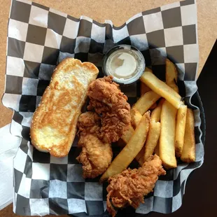 a basket of fried fish and fries