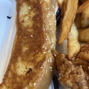 a sandwich and fries on a styrofoam container