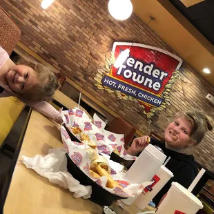 two children eating hot dogs