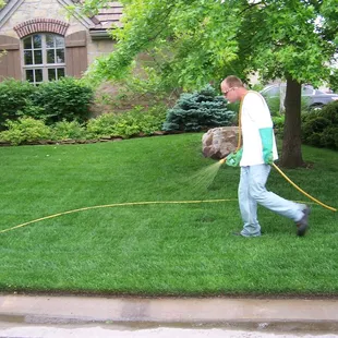 a man watering a lawn