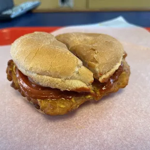 Tender Sandwich with hot sauce, mustard, onion, tomato