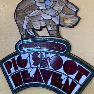a stained glass sign with a horse on top