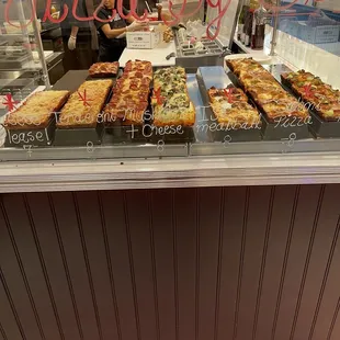 a display of a variety of pizzas