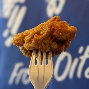 a piece of fried chicken on a fork