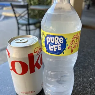 a bottle of pure life and a can of coke