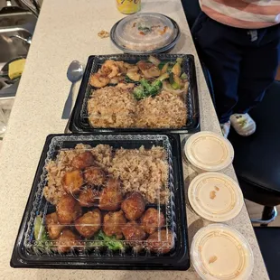 two trays of food on a counter