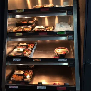 a display case with a variety of food items