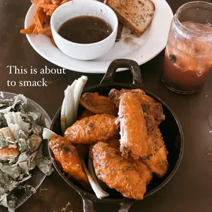 a plate of chicken wings and a bowl of soup