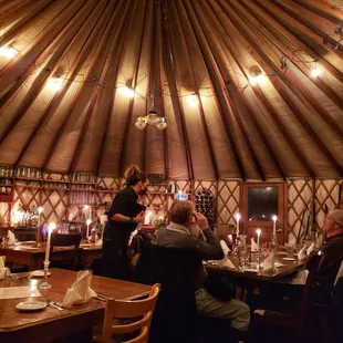 Inside the cookhouse Yurt, a cozy candlelit hideaway