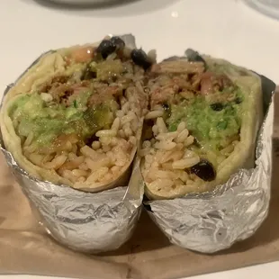 Carnitas burrito with guacamole and roasted vegetables
