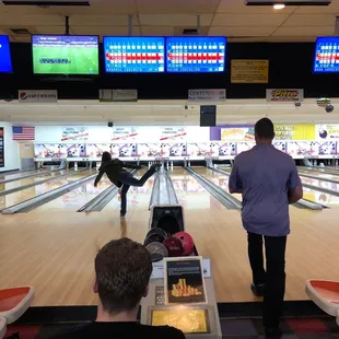 a man and a woman playing a game of bowling