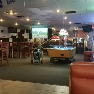 Television, pool tables in the bar area.