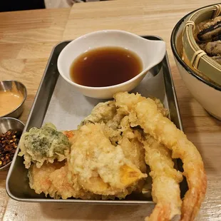 a plate of fried food and a bowl of dipping sauce