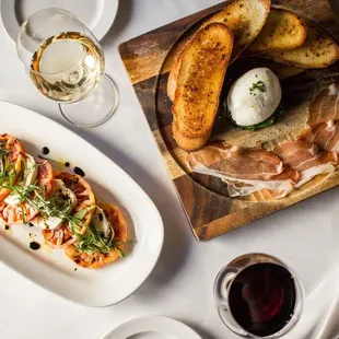 a plate of food and a glass of wine