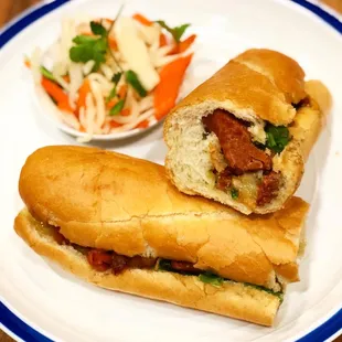 a plate with a salad and a sandwich