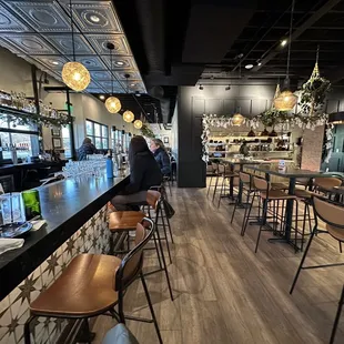 A view down the bar. The kitchen and main seating is on the right. There is also more seating beyond the bar.