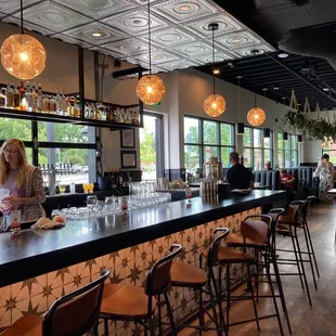 a woman standing at a bar