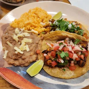 Taco dinner: refried beans, rice, cauliflower taco, grilled octopus taco