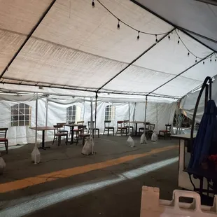 a tent with tables and umbrellas