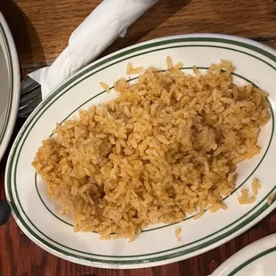 a plate of rice and a bowl of soup