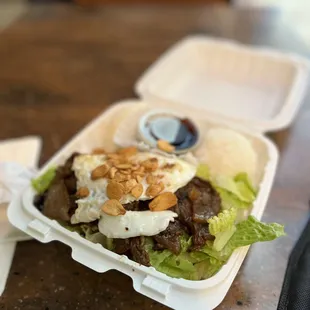a salad in a styrofoam container