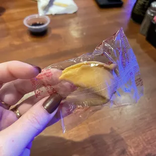 a person holding a piece of food