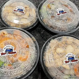 four plastic containers of food