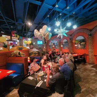 a group of people eating at a restaurant