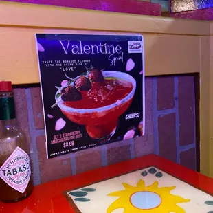 a table with a hot sauce on it