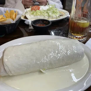 "THE BIG ONE" Ground beef, shredded chicken or shredded beef, rice, beans, tomato, lettuce, sour cream topped with white queso.