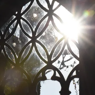 the sun shining through a stained glass window